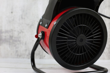 Heater for the apartment, closeup. Electric halogen fan heater on floor. Heat gun with a fan for heating. 
