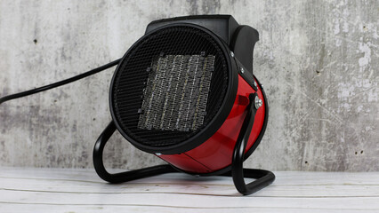 Heater for the apartment, closeup. Electric halogen fan heater on floor. Heat gun with a fan for...
