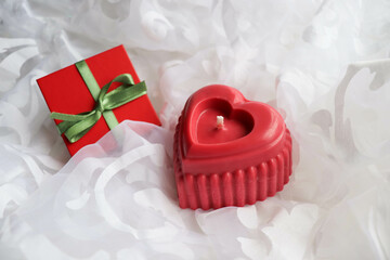 valentine's day background. handmade soy candle made of natural soy wax in the shape of a red heart