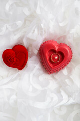 valentine's day background. handmade soy candle made of natural soy wax in the form of a red heart and a wedding ring