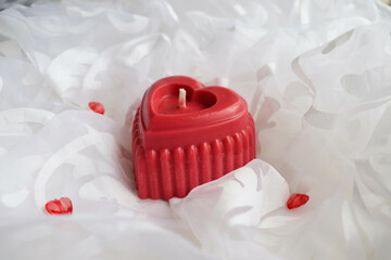 valentine's day background. handmade soy candle made of natural soy wax in the shape of a red heart