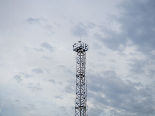 A tower at a strategic facility. Lookout tower. Thin high sentinel point with spotlights