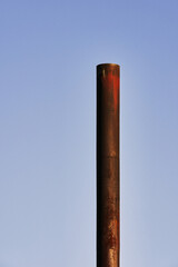 old industrial rusty chimney glowing in the autumn light