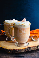 Pumpkin Spice Hot Chocolate Topped with Whipped Cream: Mugs of hot chocolate topped with chantilly cream and pumpkin spice