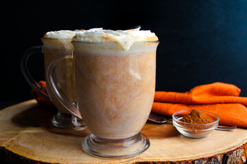 Pumpkin Spice Hot Chocolate Topped with Whipped Cream: Mugs of hot chocolate topped with chantilly...