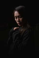 Asian young woman who wants to express something with expression. Asian female model wearing black t-shirt on bokeh background.