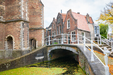 Fototapeta na wymiar Scenic view of ancient houses and a bridge over a canal in the old town of Delft, Holland