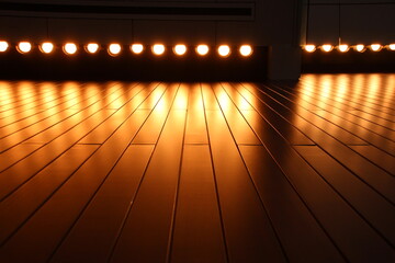 Illuminated theater stage in a front flush to floor view