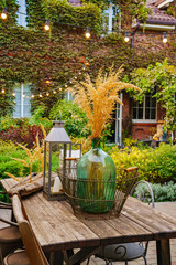 beautiful summer courtyard. wooden table with retro items.