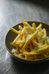 Oven Baked Garlic and Parmesan crispy Fries on a metal table on a dark background. Soft focus. selective focus. Closeup.