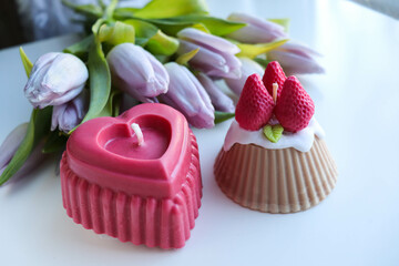 valentine's day background. handmade soy candle made of natural soy wax in the shape of a red heart	