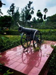 Vertical closeup of an ancient big war gun exhibition in a park