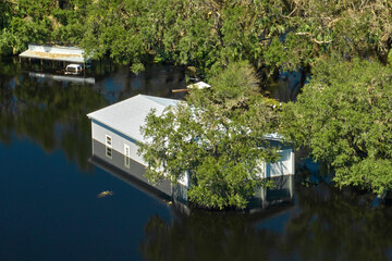 Flooded house by hurricane Ian rainfall in Florida residential area. Consequences of natural...