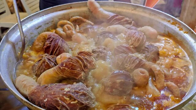Turkish Street Flavor Lamb Offal Cooked in a Large Pot Sirdan Footage. Traditional Turkish Stuffed rice tripe or offal food on the table in Turkish Restaurant. Sirdan Dolma is the favorite food Adana.