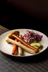 assorted sausages with sauces on plate on wooden table vertical