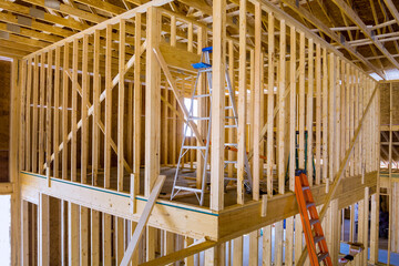 Building frame for new residential building while it is still under construction with beams fenestrations on construction site