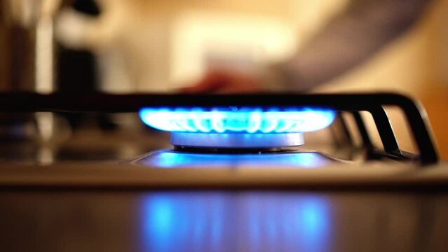 Turning on a gas stove in close up view
