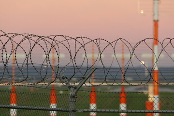 Security fence around airport at dusk