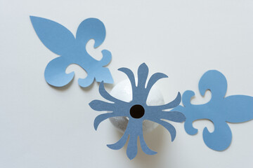 decorative rosette isolated on a vase with fleur-de-lys shapes on blank paper