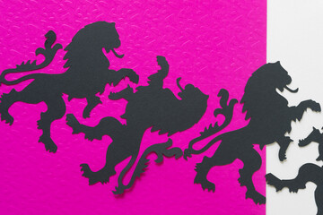 randomly arranged heraldic lion glyphs or dingbats on embossed hot pink and blank paper background