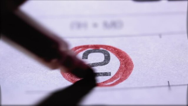 Mark on calendar on second day of the month, boldly underlined with a red felt-tip pen, close-up