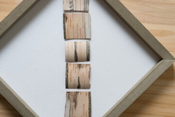 birch bark squares arranged inside a framed panel