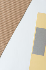 paper background with plain brown corrugated cardboard and gray and yellow paper