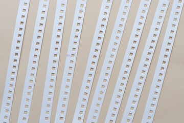 background with paper stripes containing square holes - arranged slightly diagonally (on vertical)