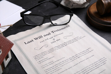 Last will and testament near glasses on black table, closeup