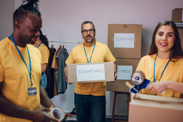 Group of multiracial volunteers working in community charity donation center