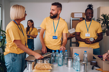 Group of multiracial volunteers working in community charity donation center