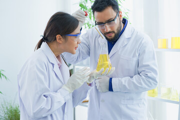  man-woman scientist with expertise in laboratory research biology discovery test tube analyzing...