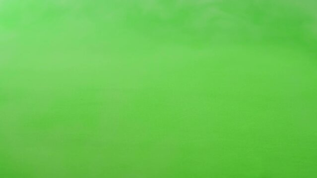 Smoke on green chroma key background. Smoking, steam clouds of vapour close-up. Burning, fog. 