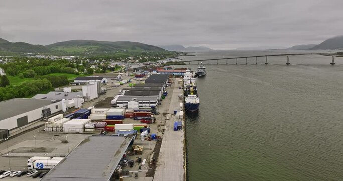Sortland Norway v3 low level flyover harbor town waterfront quay along sortlandsundet strait with cross water sortlandsbrua bridge in the background - Shot with Mavic 3 Cine - June 2022