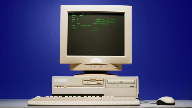 Retro pc with loading code console, programmer making scripts, green basic screen, Old computer studio blue night background close-up, Desktop vintage retro wave display, late 90s PC.