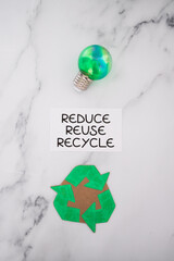 sustainability and circular economy, reduce reuse recycle sign with green light bulb and recycle icon