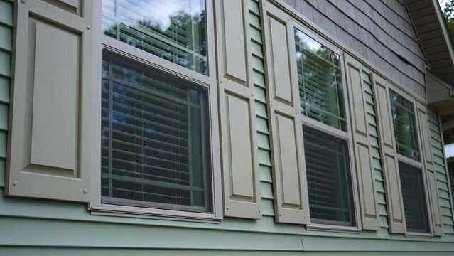 Three windows of modern luxury home as seen from outside