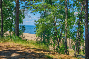 Lake Baikal coast, hill with forest, water bay. Summer travel, discovery of beauty of Earth. Siberia, Russia.