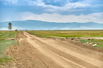 The road to the steppes of the Barguzin Valley of the Republic of Buryatia on a clear sunny day.