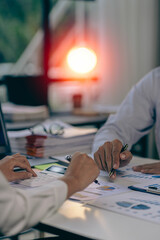 Teamwork concept, a group of business people meeting to analyze and discuss and brainstorm financial report chart data in a financial advisory office. vertical picture