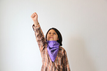 10-year-old Hispanic girl wears a purple headscarf representing the struggle for feminism and...