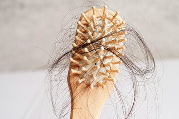 Hair loss fall with comb brush isolated on white background.