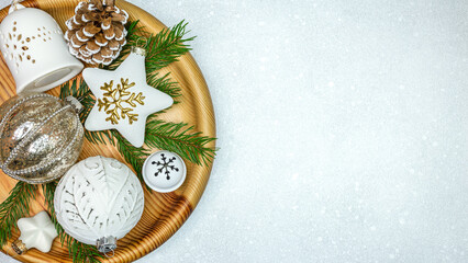 christmas decorations with stars, jingle bell and glass balls on wooden tray