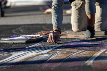 Artist drawing at a chalk art festival