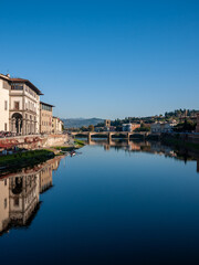 Fototapeta na wymiar Florence, Italy - November, 2011: a bridge on arno river on sunny day