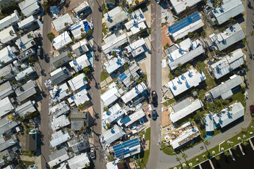 Severely damaged houses after hurricane Ian in Florida mobile home residential area. Consequences of natural disaster