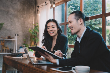 Two businessperson enjoyed meeting on the project. two partner discussing business planning with technology.