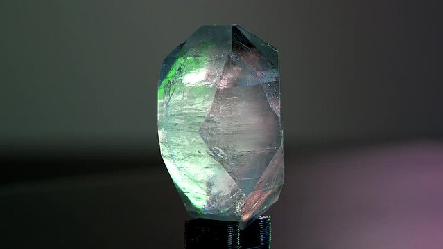 A precious rough stone for jewelry production rotates on an exhibition display