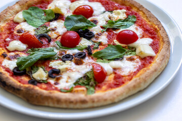 pizza with salami and tomatoes