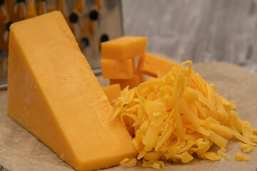 cheddar cheese with grater and grapes